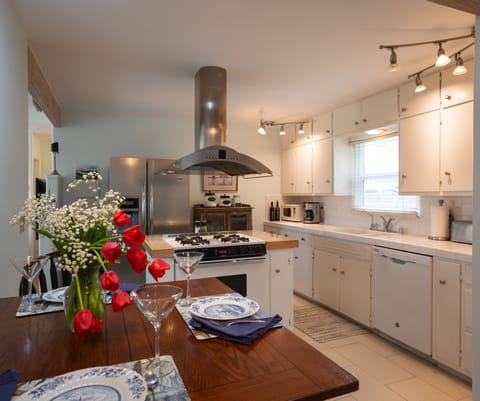 Kitchen dining, newer dishwasher and gas range. 2 door refrigerator on far wall.