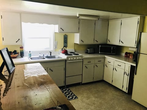 Fully stocked kitchen with large custom counter for cooking/entertaining 