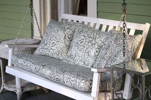 Enjoy a cup of coffee on the front porch swing