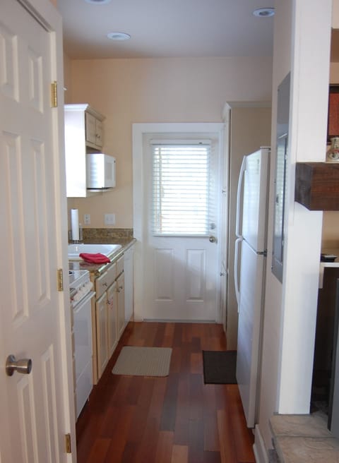Galley Kitchen...Stove, dishwasher, refrigerator and washer/dryer in the corner.