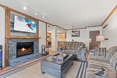 Living room with stacked slate fireplace and Smart TV
