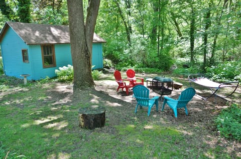 Firepit area with four chairs and hammock