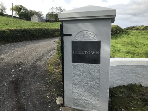 Driveway entrance with house in the background