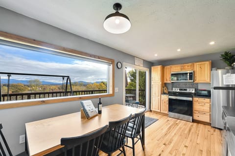 Large 8 person dining table looks out to amazing mountain view