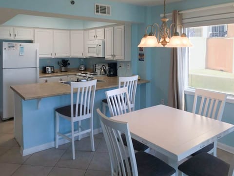 Dining table and breakfast bar provide ample seating at meal time