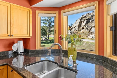 Sunlit kitchen with granite counters and scenic window views