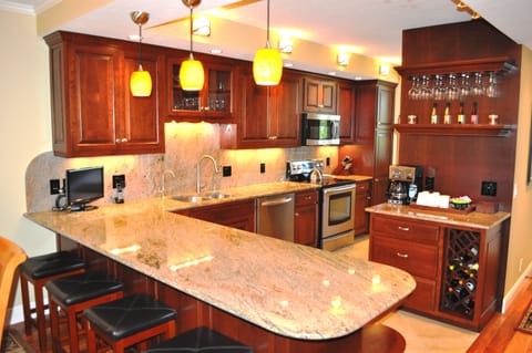 Beautiful, bright kitchen with custom premium cherry cabinets and granite tops