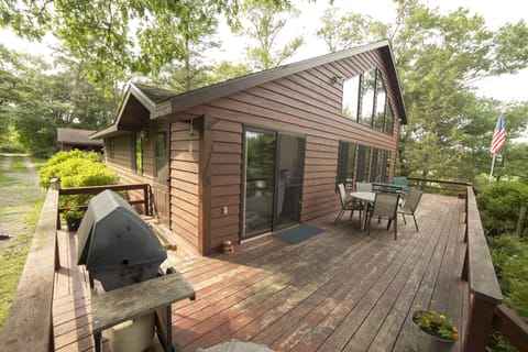 Large lake facing deck, with patio table and chairs.  Gas and Coal Grill.  
