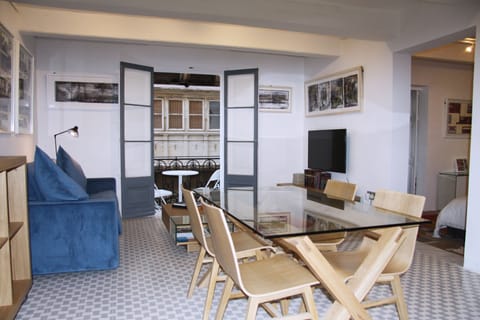 gallery suite living dining TV area onto bright Juliet wrought iron balcony 