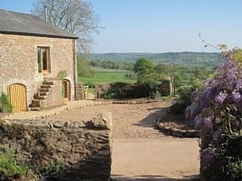 View across cobbled courtyard from farmhouse