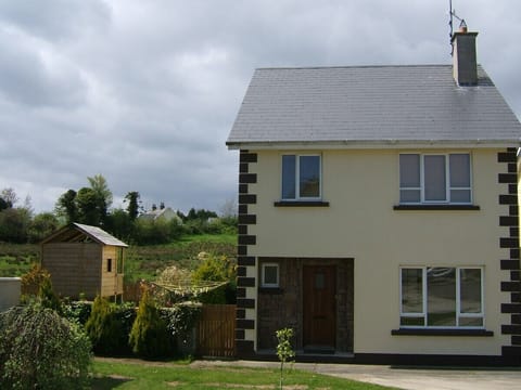 Front of house/ kids playhouse in rear garden