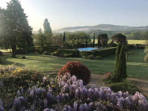 View from bedroom window of garden and pool