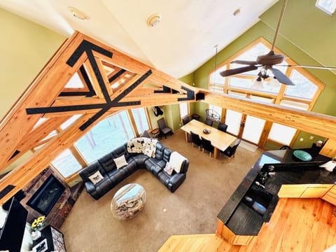 Open floorplan living room with access to kitchen, dining room, bathroom, patio