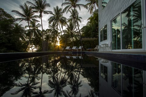 The "Gardenia" villa private swimming pool has a hanging swing chair!
