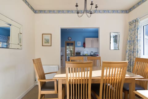 Separate dining room with contemporary luxury light oak furniture.