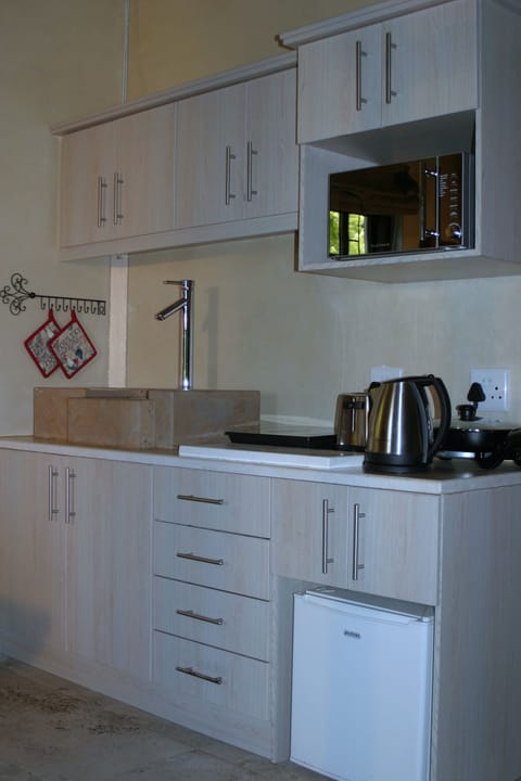 Fully equipped kitchenette with cooking appliances & utensils, crockery & cutler