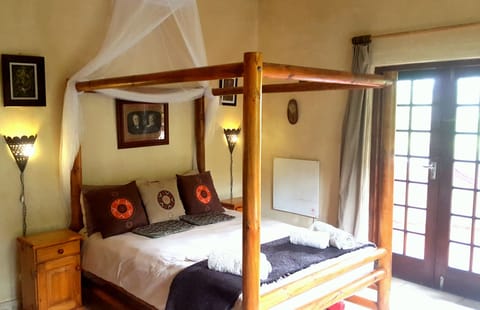 Four poster double bed with mosquito net.