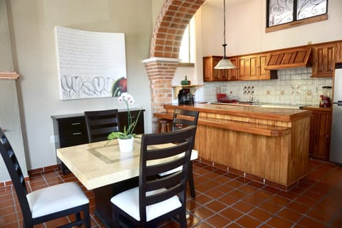 Kitchen & dining area. Entrance to the right and living room to the left.