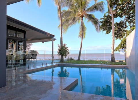 Sparkling salt pool with sea views surrounded by glass pool fence.