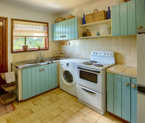 Full kitchen with stove, microwave, washing machine etc