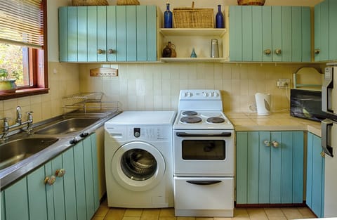 Full kitchen with stove, microwave, washing machine etc