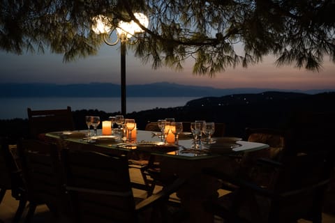The dinning table in the pool house's patio at sunset
