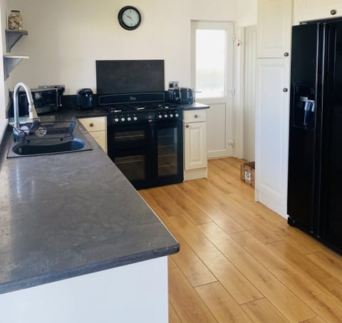 kitchen dinner with seating comprising of benches, dining chairs and a sofa