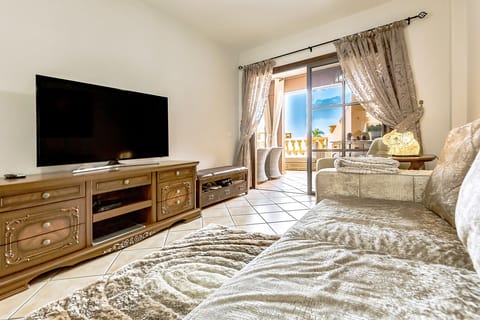 Living room with plasma TV and a little view to the balcony