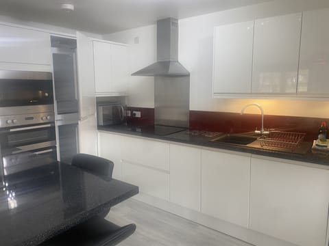 kitchen with 2 ovens, fridge freezer, dishwasher, microwave