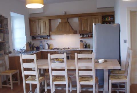 The large oak table that can seat 8 and the bespoke oak kitchen