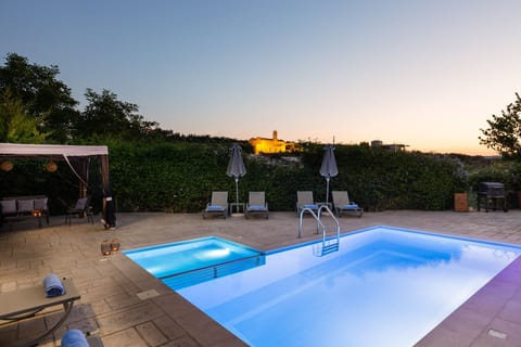 Calm summer nights by the pool with a view to the ancient church.