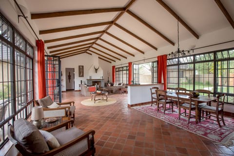 Open plan living/dining area with fire place and access to courtyard and fairway