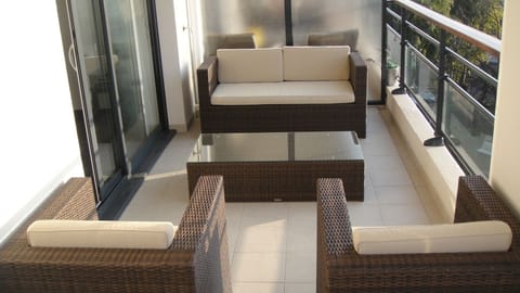 One end of the terrace, other end of terrace has a table with 6 chairs