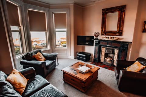 Large lounge area with original fireplace and stunning sea views