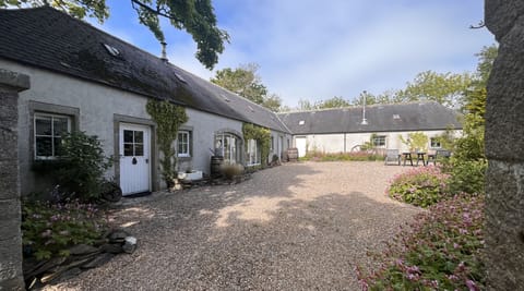 The Coach House cottage with private entrance and gravelled courtyard.