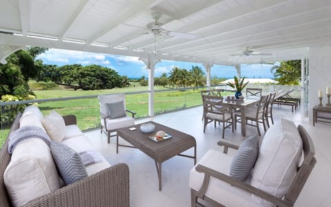 Patio area with dining for 6 with seating and loungers overlooking 18th hole.
