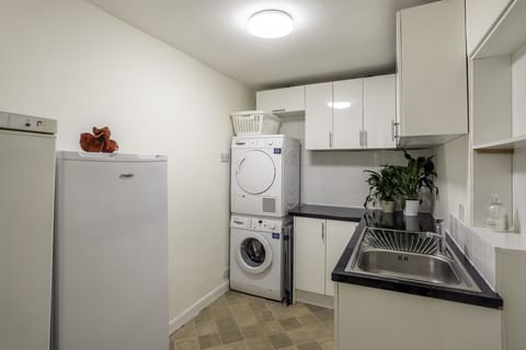 Utility room with extra fridge and freezer space and washer/dryer
