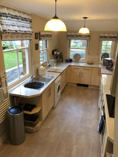 Kitchen leading to garden areas and stairs to bed 6