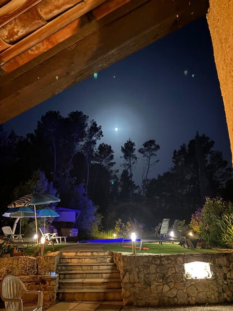 View of pool from terrace illustrates the ambiance of swimming pool by moonlight