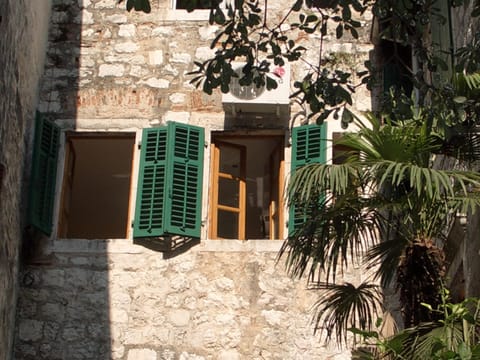 View of apartment windows from small alley outside. 