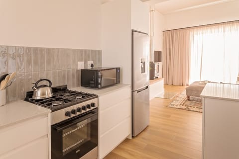 Kitchen with gas hob, electric oven, microwave and fridge/freezer