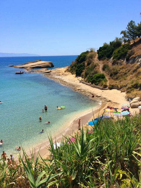 Sandy, cute Spartia beach: shallow, warm waters, few rocks around for snorkeling