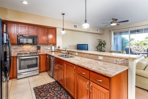 Well equipped kitchen with full size stainless appliances, granite counters and plenty of storage.