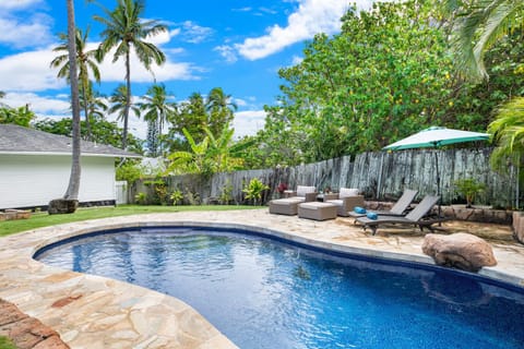 Unwind by the private pool at Lanikai Cottage, surrounded by tropical greenery and island breezes.