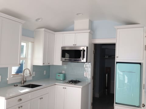 Kitchenette with 2 burner gas range.  Microwave is a convection oven. 