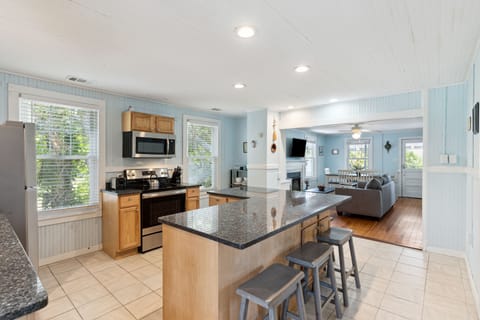 The top floor kitchen is fully stocked to cook homemade meals and offers a breakfast bar that seats 6 people.