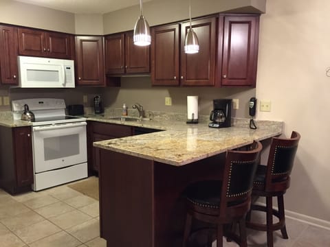 Newly remodeled kitchen with new appliances, granite top counter with bar stools