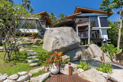 This villa is built into a lush hillside property with views across Gulf of Siam