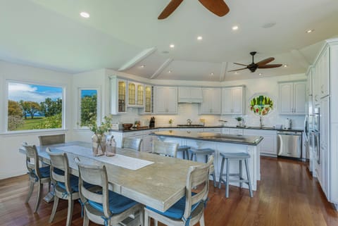 Gourmet kitchen featuring a large island with bar seating, high-end appliances, and generous counter space for effortless cooking.