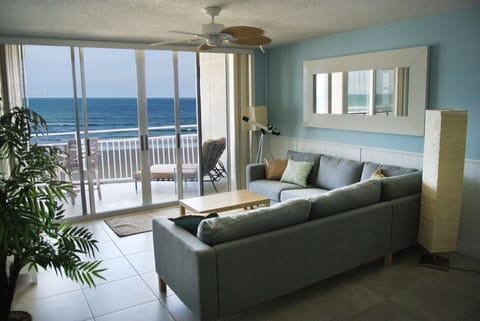 Open concept living room with beach and ocean view.